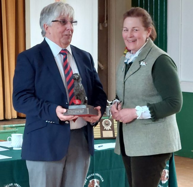 Nigel Worth collects the Harold Newman trophy from Carol Medley for Top Welsh Springer Spaniel Showdog of the Year 2021 on behalf of his wife and co-breeder Anne Worth.
